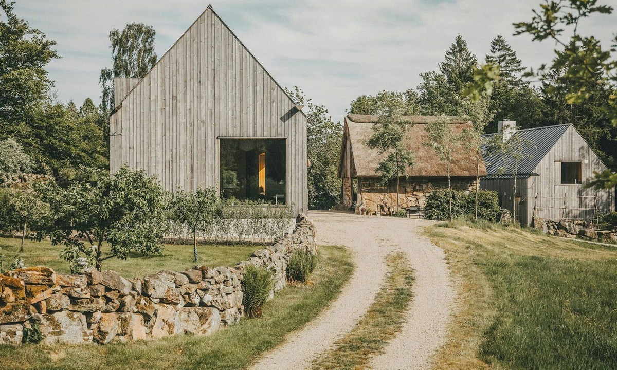 Grimeton House | Designer farm with sauna by stream in Halland