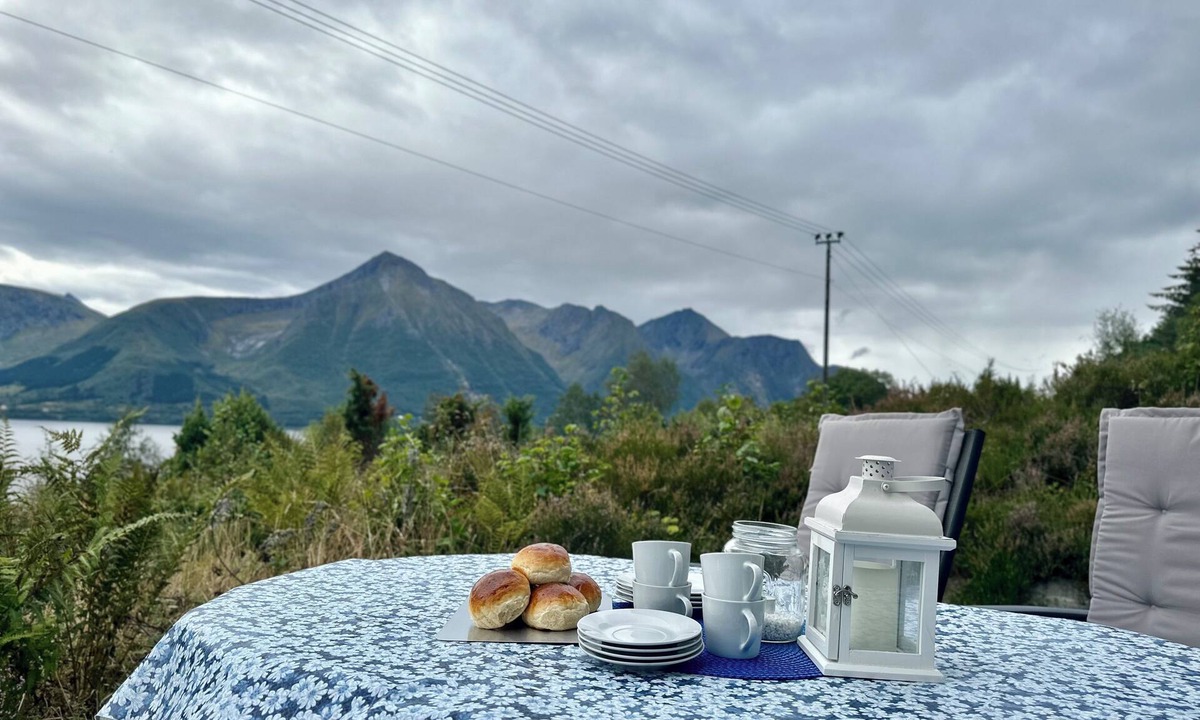 Hareid Cabin | Holiday home with view plot beyond Fjord and mountains.