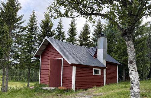 Skanland House | Rustic Cabin in Nature Outhouse & Wood Stove