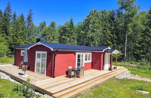 Lenhovda House | A lakeside retreat with a sauna, fireplace, boat and canoe, bicycles, and a wall-mounted charging station.