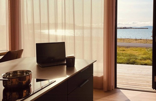 Vads House | Design cabin by the sea with Northern Lights