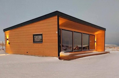 Vads House | Design cabin by the sea with Northern Lights