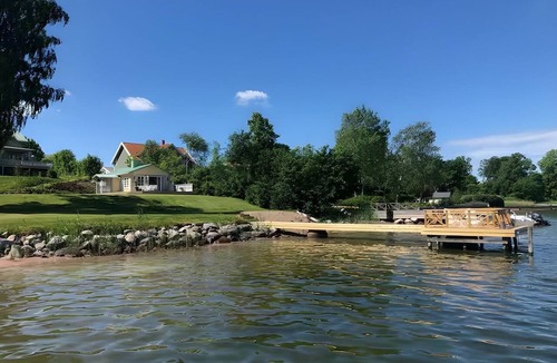 Ytterbystrand Cottage | Exclusive beach cottage with a private beach, dock, and garden