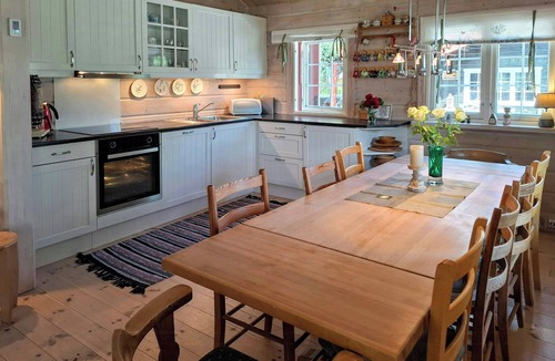 Bjorli House | Family cabin cluster by waterfall in Bjorli