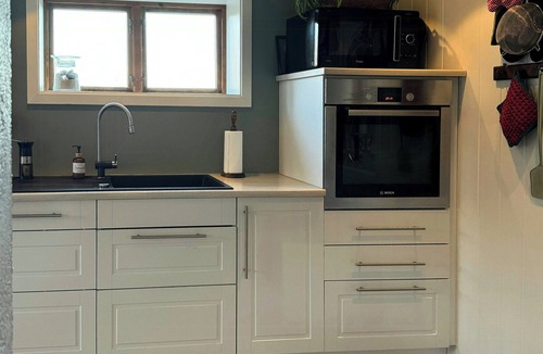 Arendal House | Red country house with lush gardens near Arendal