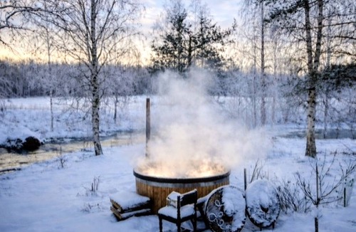 Aanekoski Ski Chalet | Riverside Cottage with Sauna, Hot Tub, and Northern Lights