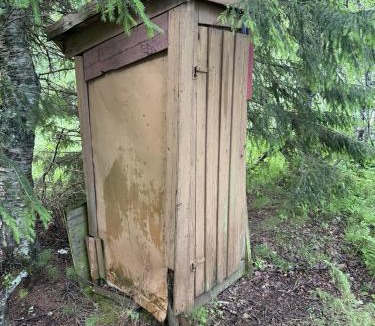 Skanland House | Rustic Cabin in Nature Outhouse & Wood Stove