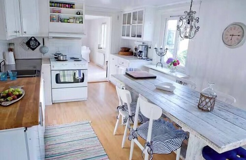 Klaedesholmen House | White wooden house on island's most charming alley