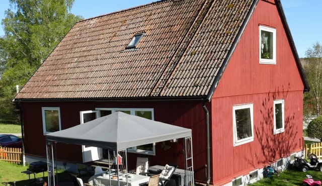A Swedish-style house with horses and a canoe trail right outside the door