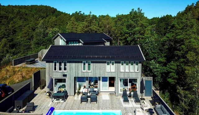 Beach villa with pool and boat dock near Trysnes
