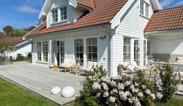 Cottage with flower garden and veranda on Hvasser