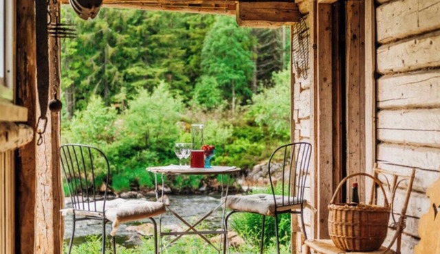 Forest cabin by the river
