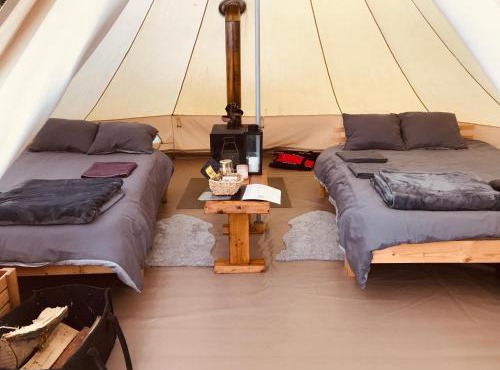 Glamping tent in a forest, lake view