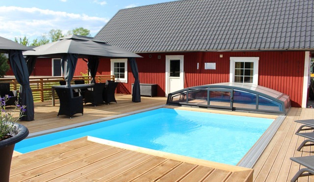 Large comfortable holiday home with private pool, motorboat and lake view in Väckelsång
