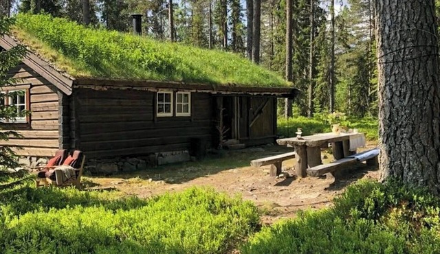 Off-grid timber cabin by river near Lillehammer