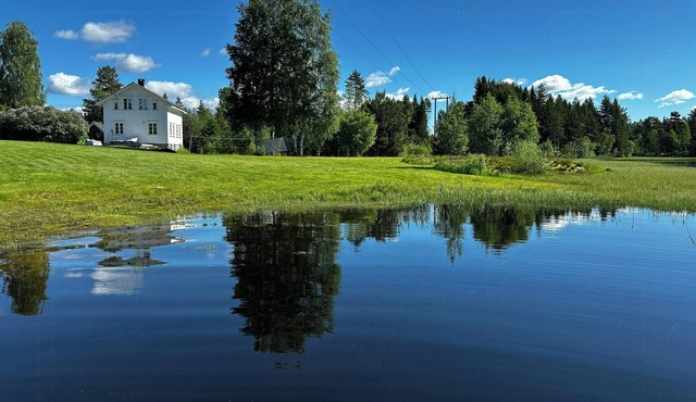 Traditional farmstead with dock near Vegår