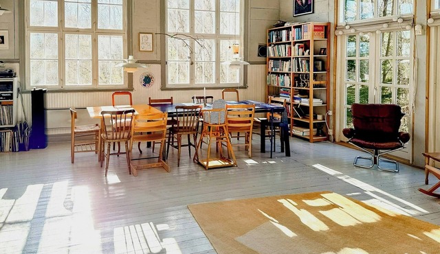 Unique historic schoolhouse near forest and river