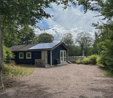 Hjarnarp Villa | Modern Log Cabin with Fireplace, Forest and EV Parking