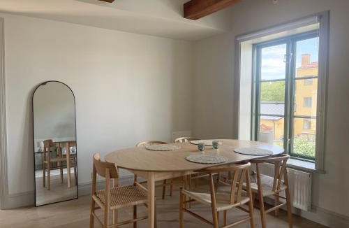 Innerstaden Apartment | Modern APT with Exposed Wooden Beams in Visby