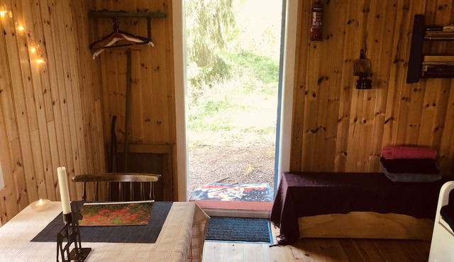 Tiny hut in the Forest Overlooking the River