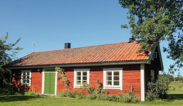 19th-century log cabin on a large rural plot